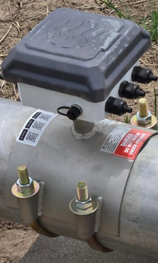 Closeup image of a flow meter installed in an outdoor pipeline. 