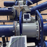 Blue pipes, green flow meters, white electronics